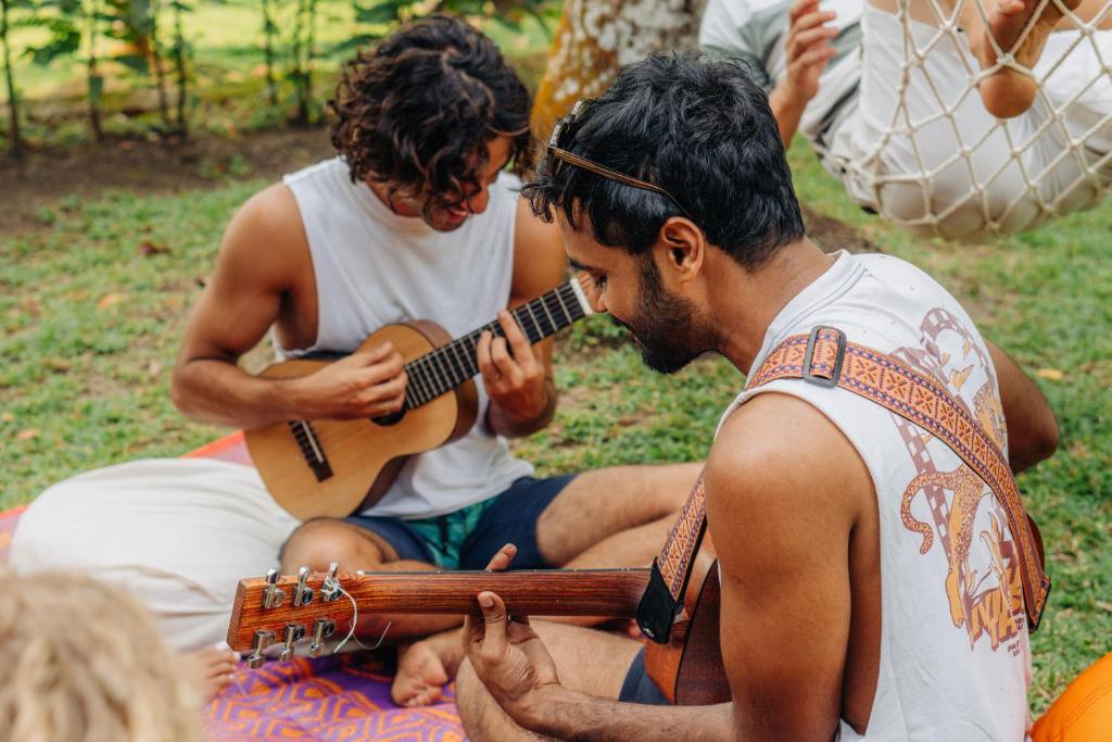 Guests playing guitar together in the garden