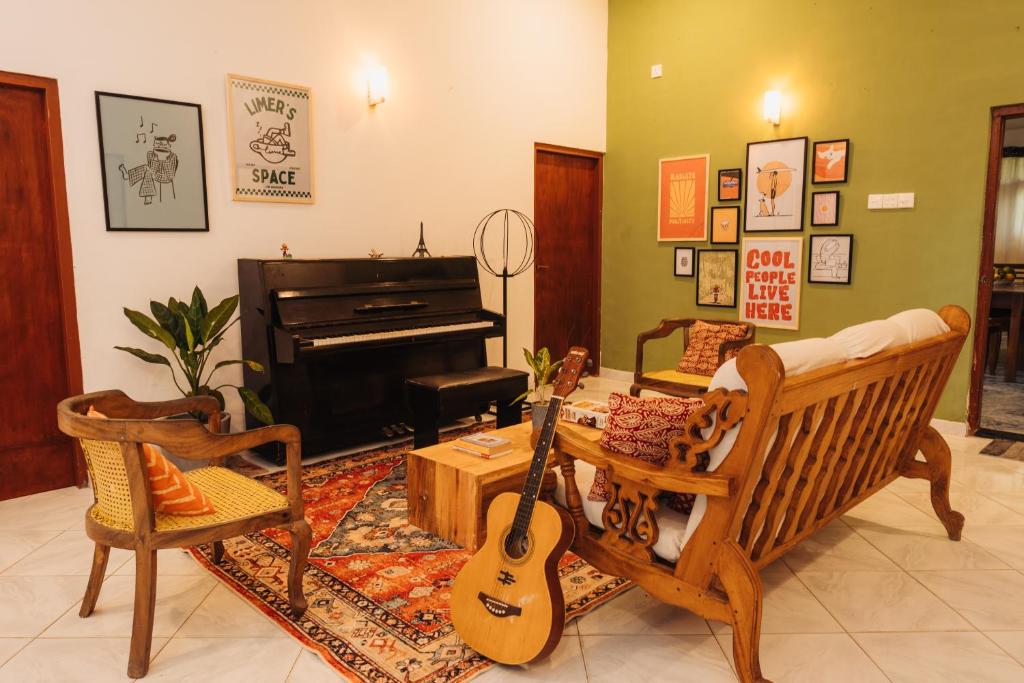 Lime's colourful lounge with a piano and guitars